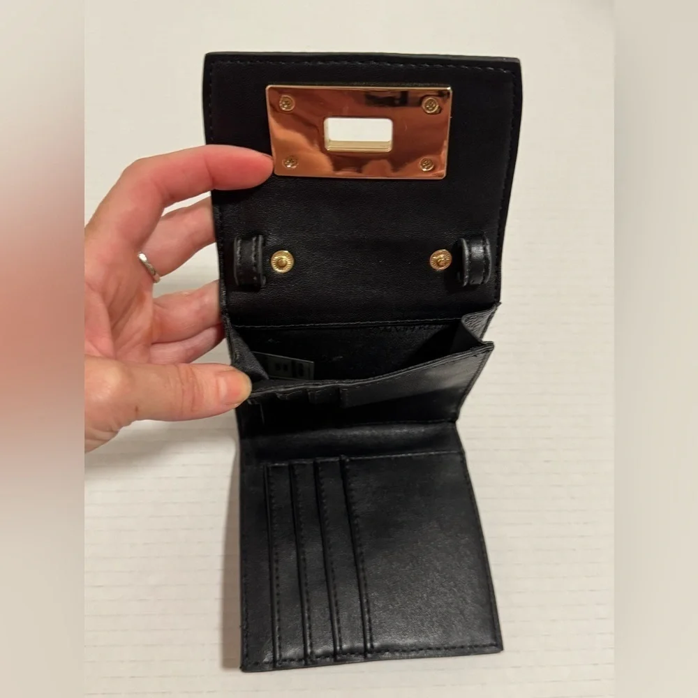 Calvin Klein black trifold wallet with a gold-tone metal closure